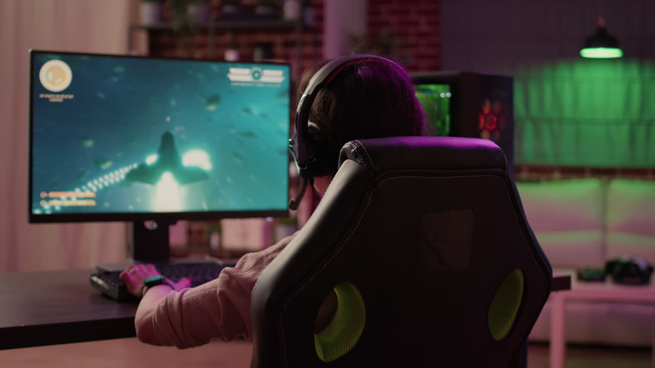 Over shoulder view of gamer girl relaxing playing rpg action game on professional pc setup