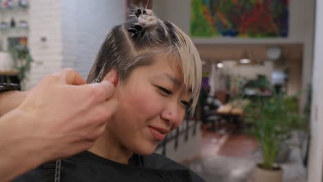woman getting a haircut in a hair salon
