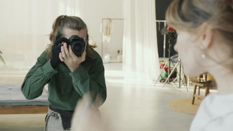 photographer capturing portrait of model in modern studio