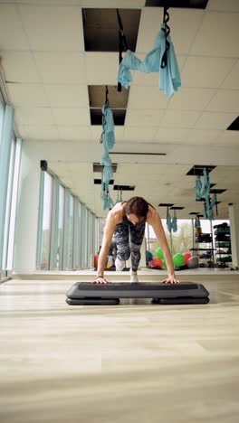 a fit woman performs various exercises showcasing strength and endurance in a fitness gym a fit woman performs various exercises showcasing strength and endurance in a fitness gym