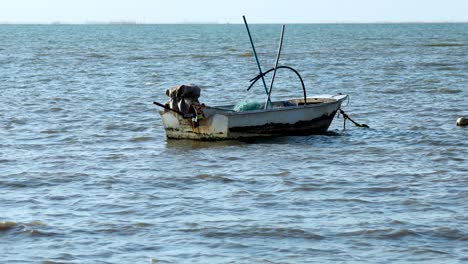 a small boat gently drifts on the sea