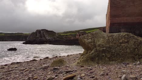 Porth-Wen-aerial-view-abandoned-Victorian-industrial-brickwork-factory-remains-descent-to-Anglesey-eroded-coastline