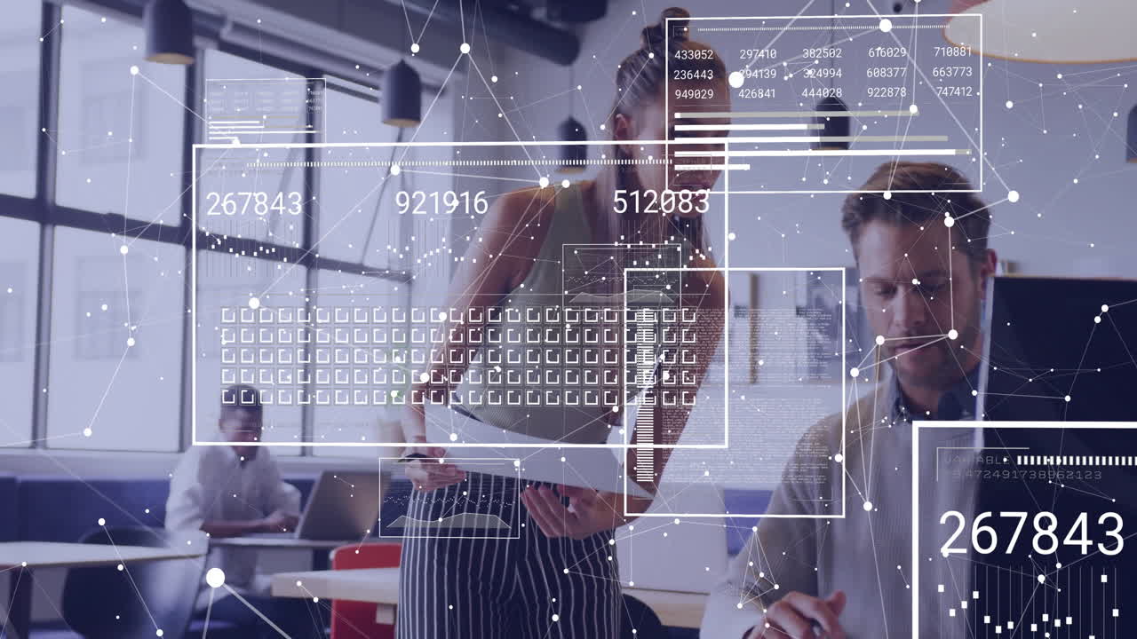 Woman reviewing document in office while coworker typing and data overlays showing business charts