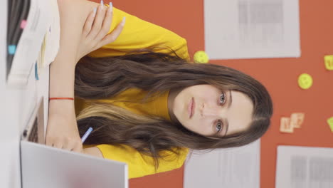 Vertical-video-of-Girl-child-at-home-looking-at-camera-with-a-calm-expression.