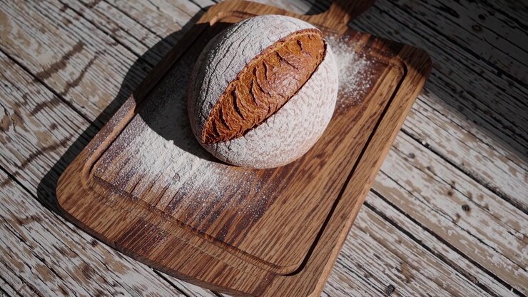 Freshly Baked Sourdough Bread on a Wooden Cutting Board
