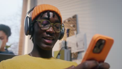 young person using a smartphone in a home office