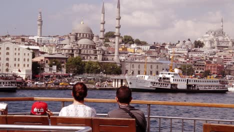 a family watching old city of istanbul and the suleymaniye mosque from a departing boat