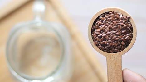 flax seeds in a wooden spoon