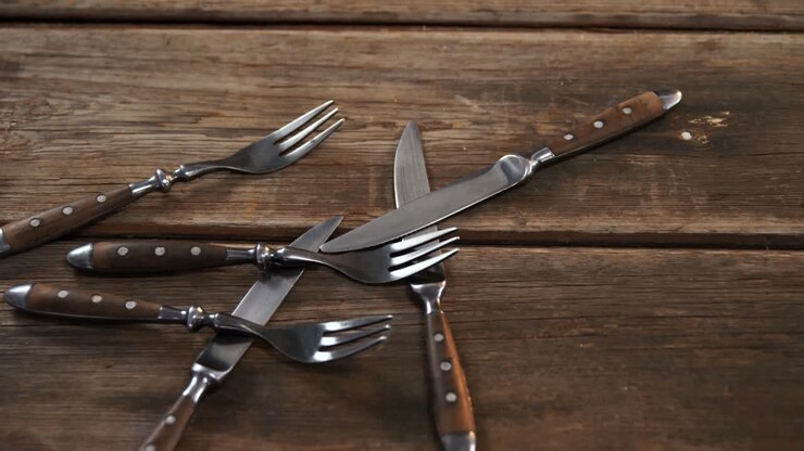 Various cutlery on wooden table 4k