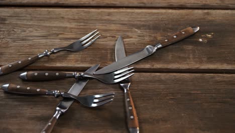Various cutlery on wooden table 4k