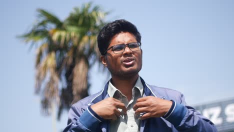 portrait of a smiling young man in a blue jacket