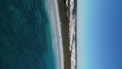 Bird's-eye-view-of-the-turquoise-water-and-white-sand-of-Wylie-Bay-Rock-Beach