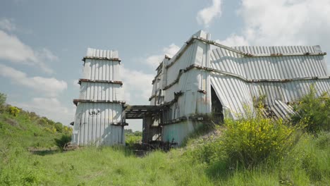 damaged isolated metal panel structure, mysterious, unstable building