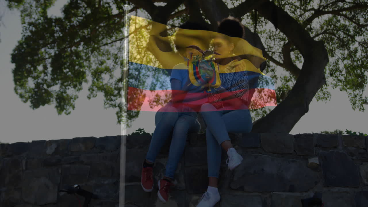 Sitting on stone wall, couple with Ecuadorian flag animation in background