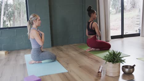 diverse women with hands on stomach and chest practicing breathing exercise in class