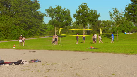 players on volleyball court in park near lyon, france.