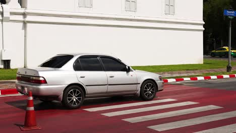 city street scene with crosswalk and car