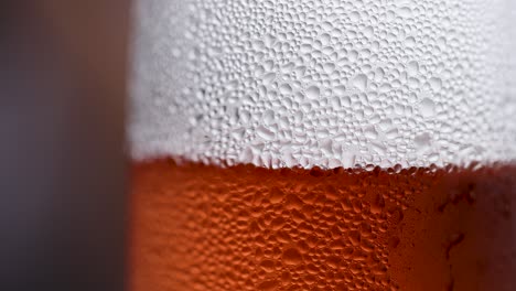 close-up video of beer bubbles rising in a glass, showcasing texture and movement with shallow depth of field