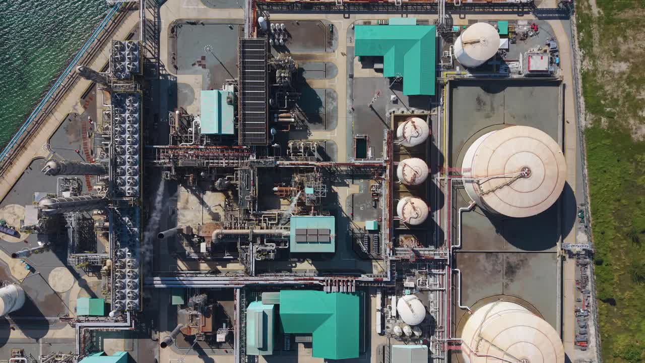 Top-down aerial view of Petronas Methanol Plant in Labuan’s Rancha-Rancha Industrial Estate, Malaysia. The complex layout of tanks, pipelines, and structures symbolizes industrial energy production