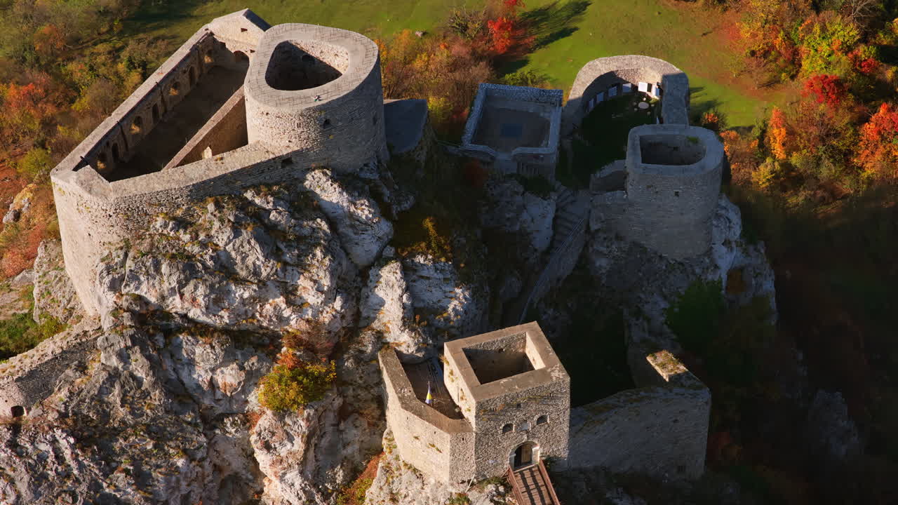 Aerial drone view of Srebrenik Fortress, a medieval stronghold perched dramatically atop a steep rock cliff in Bosnia and Herzegovina