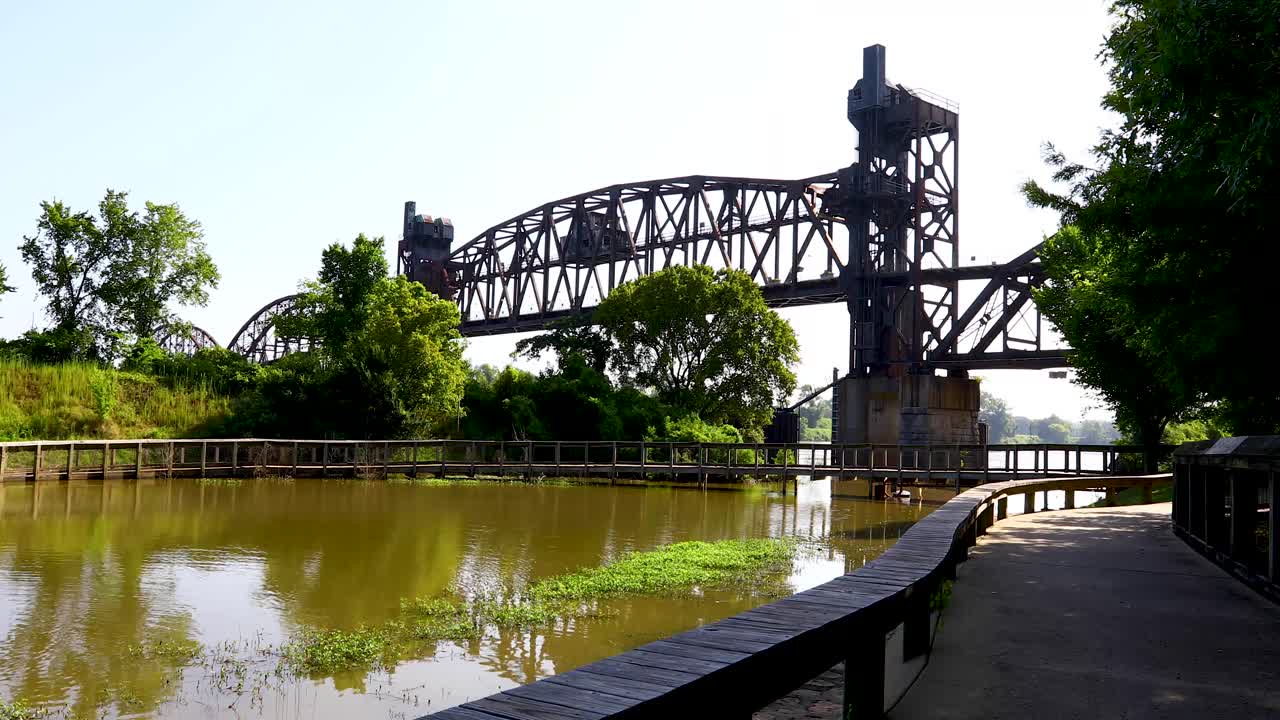 Static video of Arkansas Park Trail Bridge shot from William E. Clark Presidential Park Wetlands