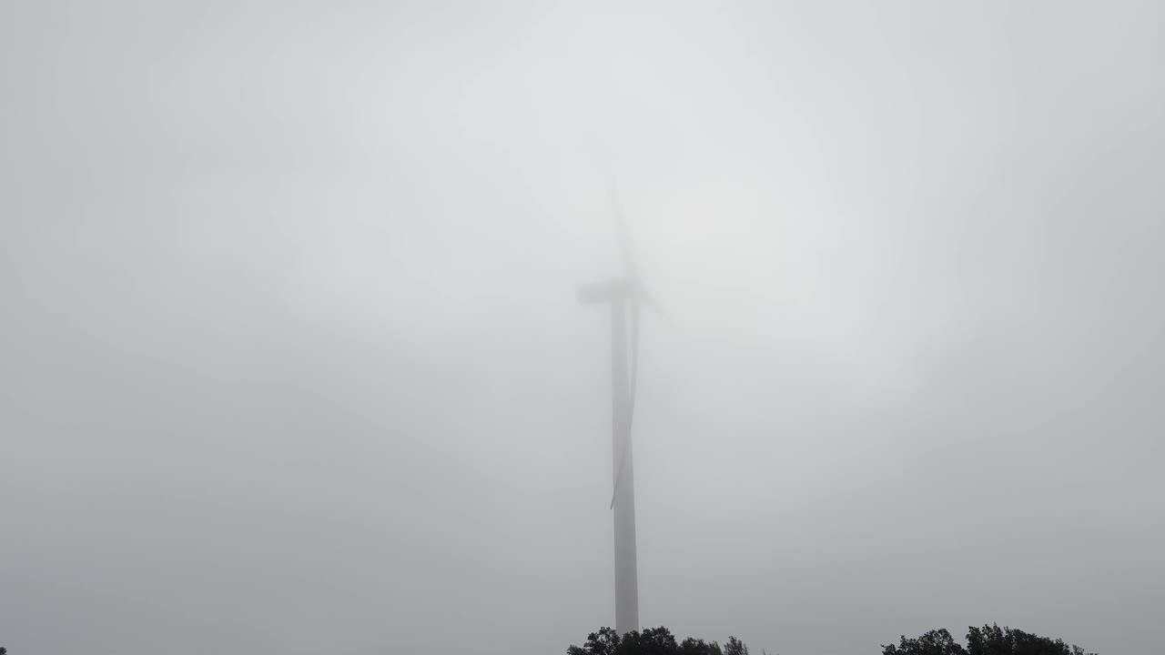 Slow wind turbine on a cloudy day