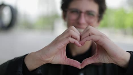 woman showing hand heart gesture