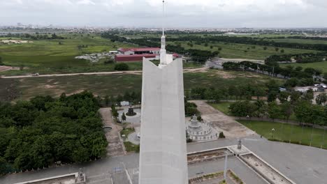 aerial footage above the win win memorial monument, phnom penh, cambodia. close up of the top of the monument and camera moves from high to to down