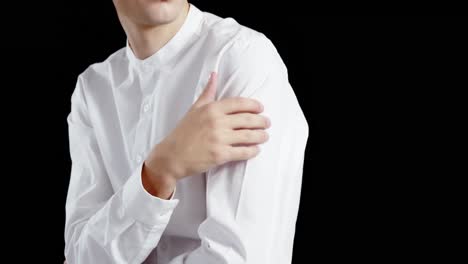 Androgynous-man-posing-against-black-background