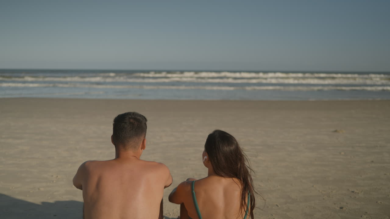 Young couple sunbathing at the beach