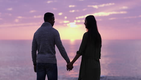 happy couple in silhouette watching the sunset