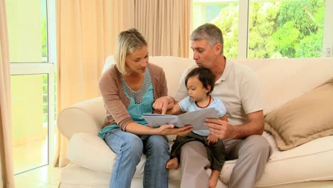 Parents-showing-their-baby-a-picture-book