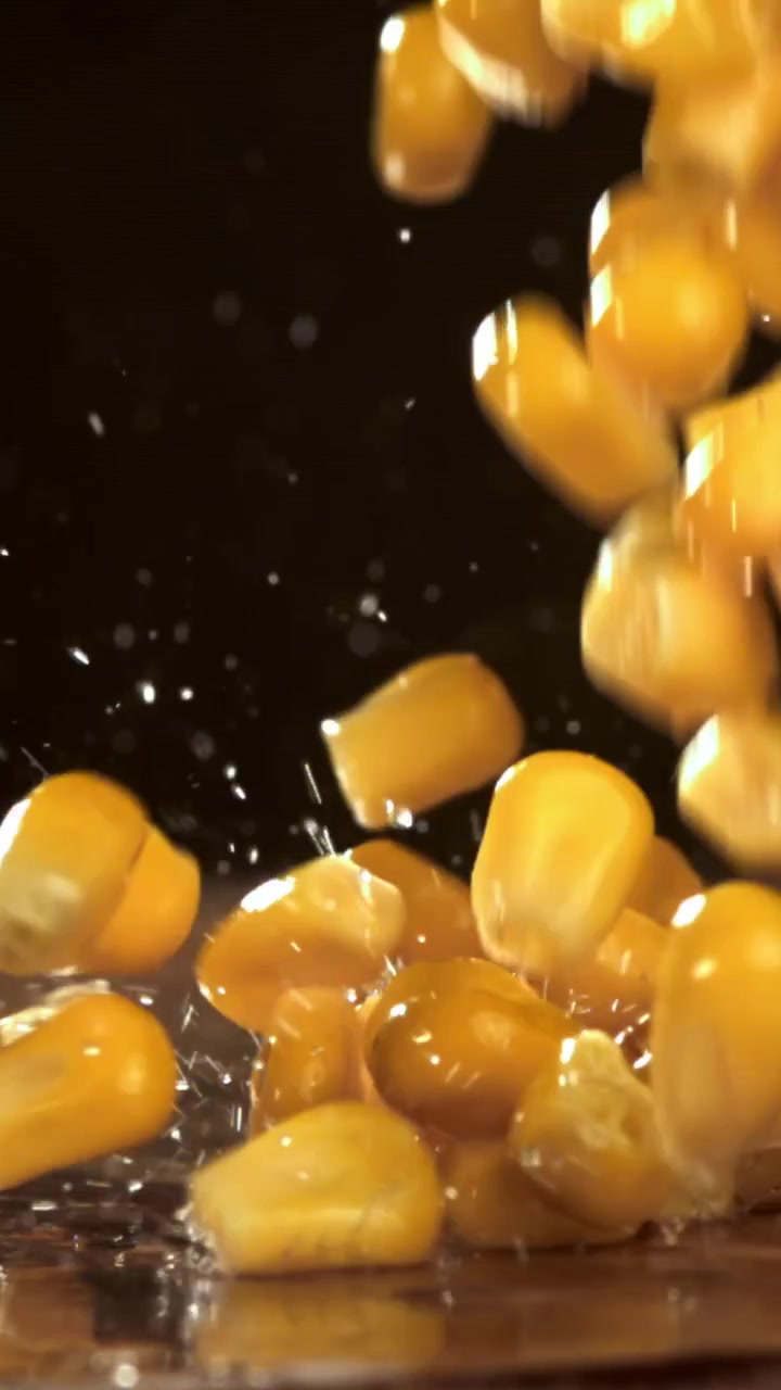 Fresh Corn Kernels Falling and Splashing in Slow Motion