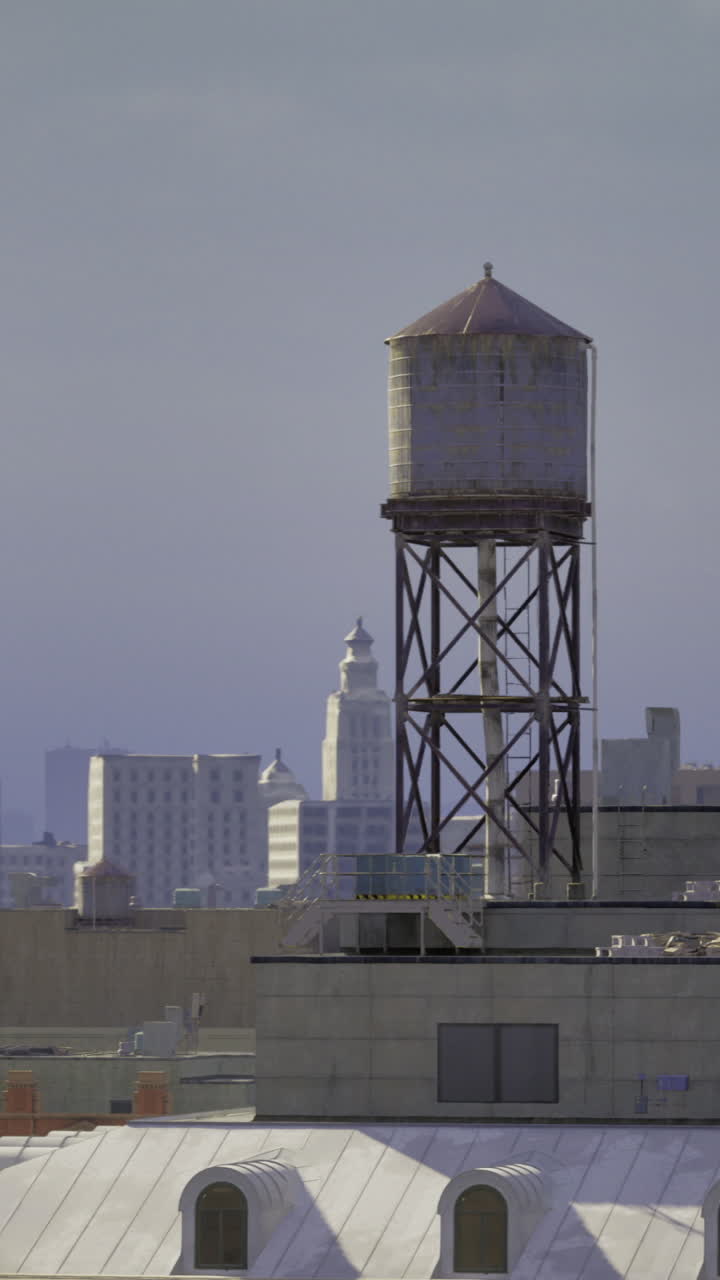 Cityscape featuring water tower with skyline in background during dusk