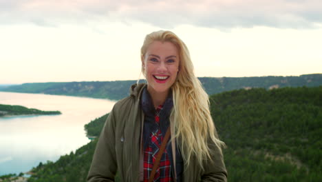 woman taking pictures of a scenic lakeside viewpoint