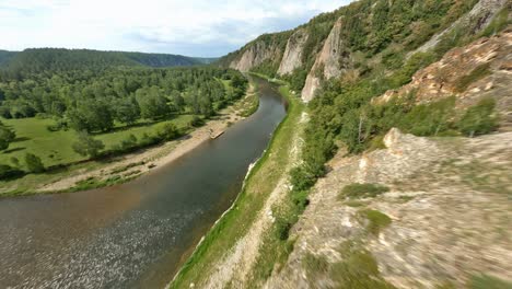 panorama of the national nature park. a boat with fisherman floats on a winding river, which skirts a small island. wild territory.
