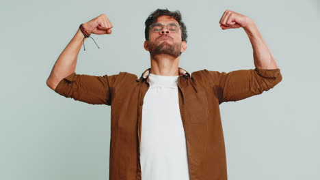 man looking confident showing biceps, feeling power strength to fight for rights, success win