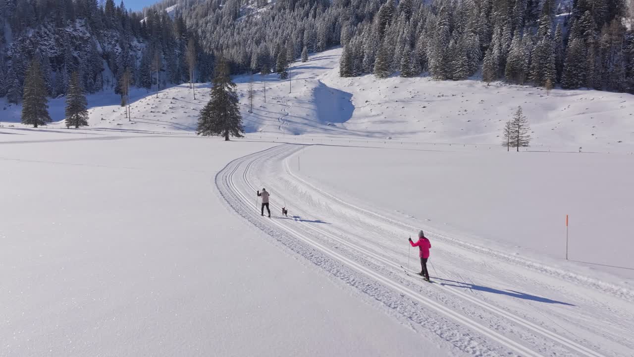 Aerial view of skiers following cross-country trails across Austrian snow