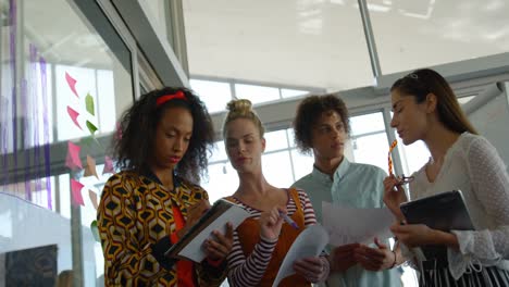 Low-angle-view-of-young-mixed-race-business-executives-working-together-in-modern-office-4k