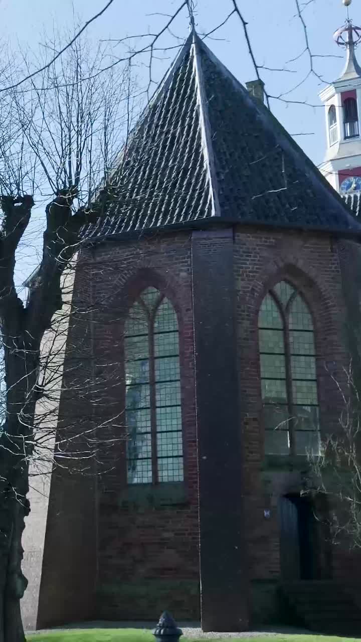 Historic Brick Church with Conical Roof and Arched Windows