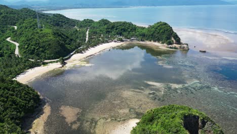 Tranquil-Beach-With-Lush-Hills-In-Virac,-Catanduanes,-Philippines---aerial-drone-shot