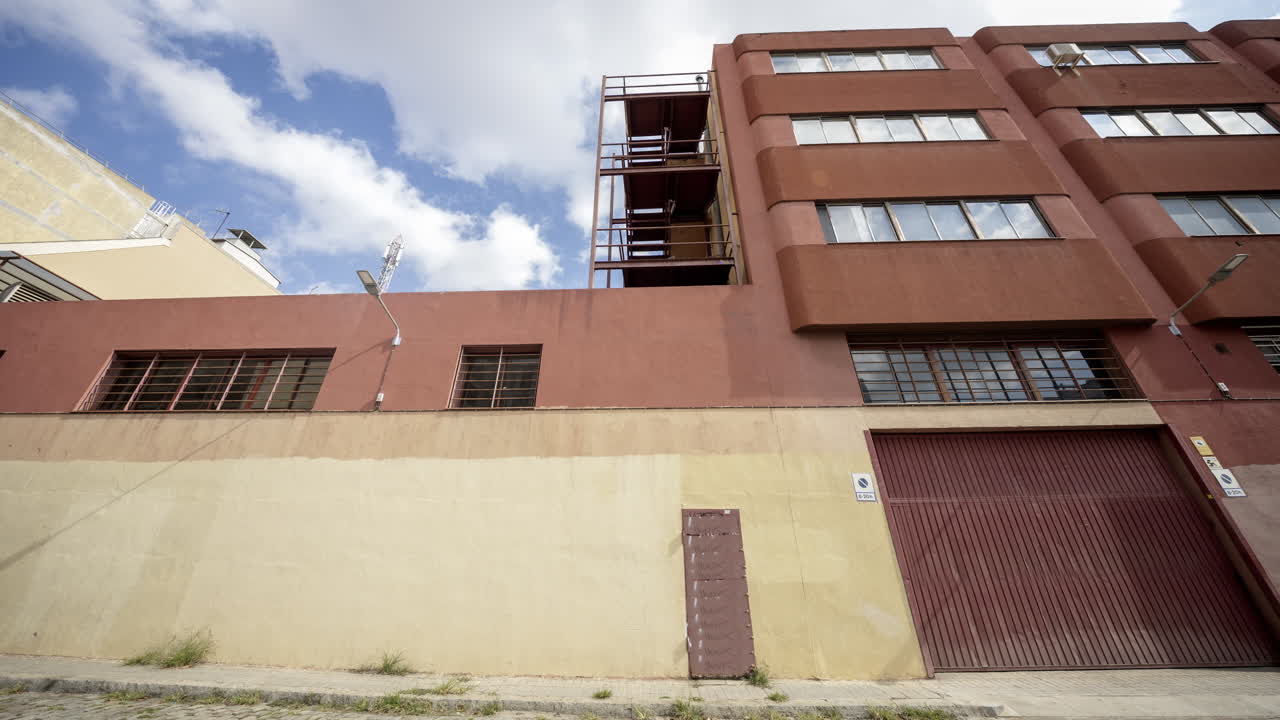 Old factory and industrial complex with passing clouds