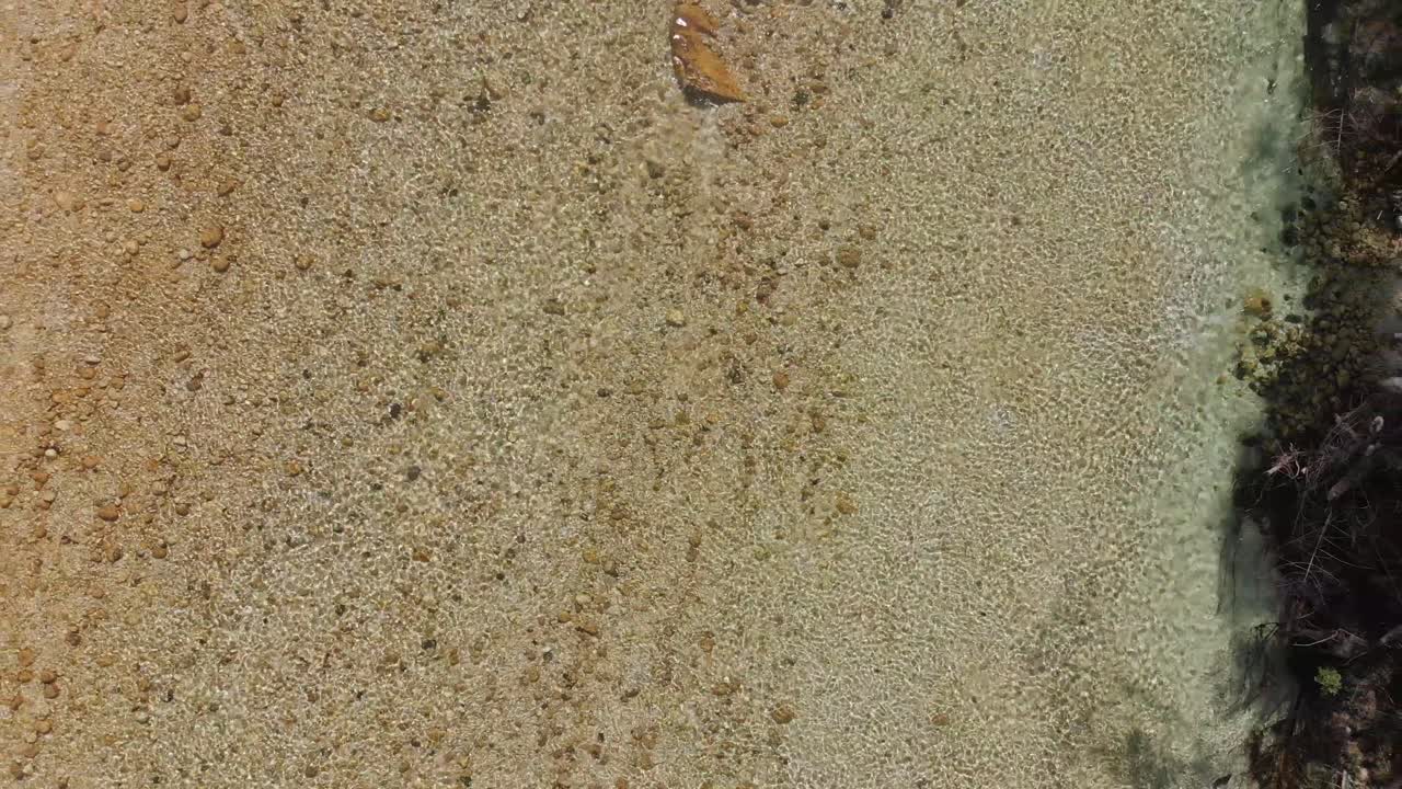 Drone lifts up over crystal clear waters of Soča River, revealing its clarity