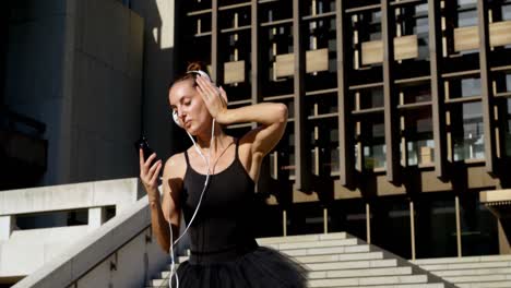 ballet dancer dancing while listening music on mobile phone 4k