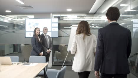 smiling business people shaking hands in office