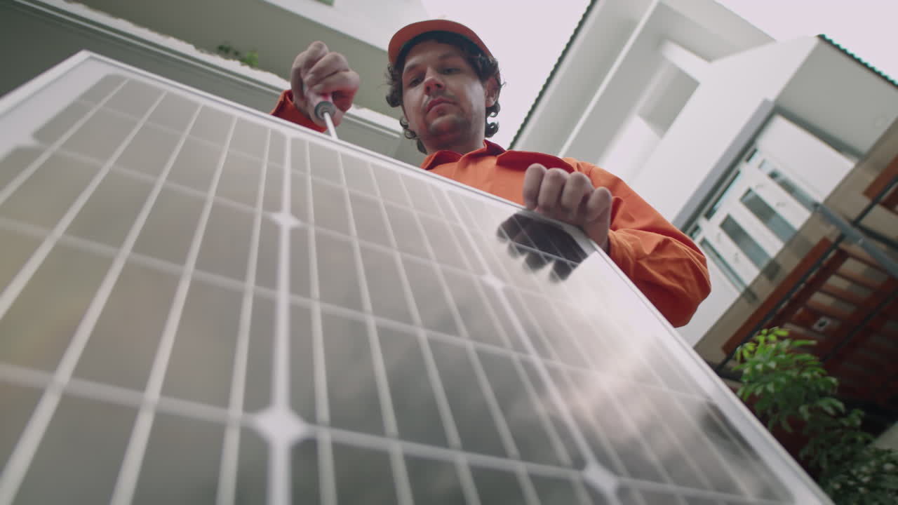 PV Installer Working with Solar Panel Outdoors