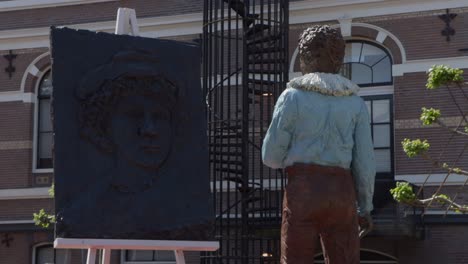 statues of young rembrandt van rijn looking at old rembrandt van rijn