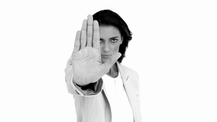 Businesswoman telling you to halt in black and white