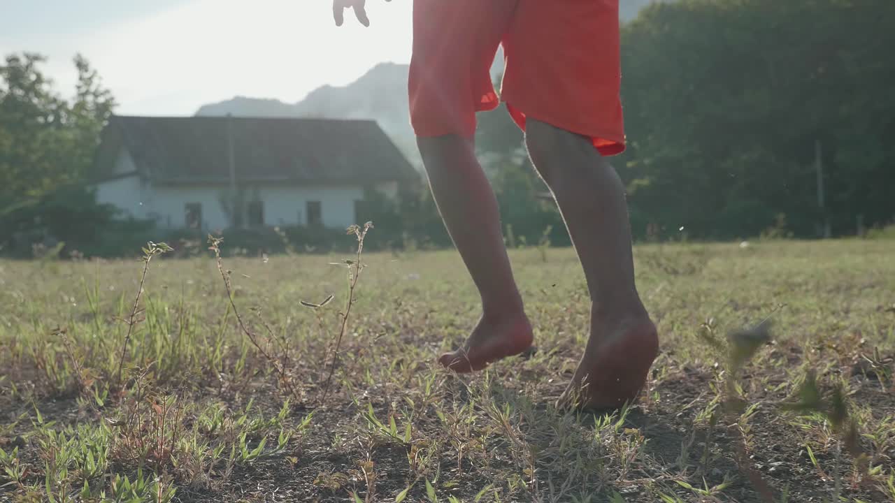 Barefoot Boy Walking in a Field