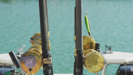 side view close up of fishing rods standing up on a boat